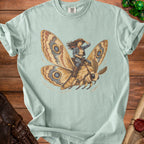 Illustration of a woman in cowboy attire riding a large moth.
