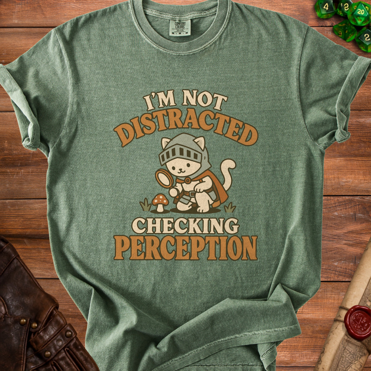 Green t-shirt with a cartoon knight cat and text: "I'm Not Distracted Checking Perception".