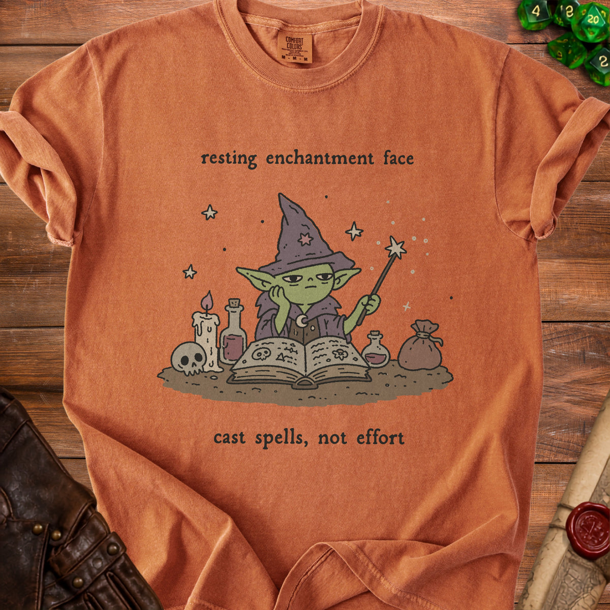 Orange t-shirt with wizard character and text "resting enchantment face" and "cast spells, not effort".