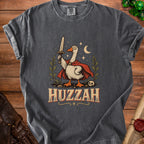 T-shirt graphic of a goose in a cape holding a sword, with "HUZZAH" text.