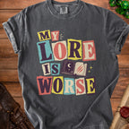 Charcoal t-shirt with "MY LORE IS WORSE" text and an open book graphic.