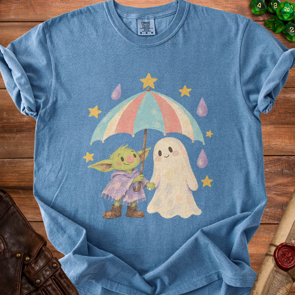 Blue t-shirt featuring a ghost and creature sharing an umbrella with stars and raindrops.