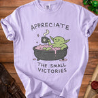 Light purple t-shirt with green creature in a bath and text "Appreciate the small victories".