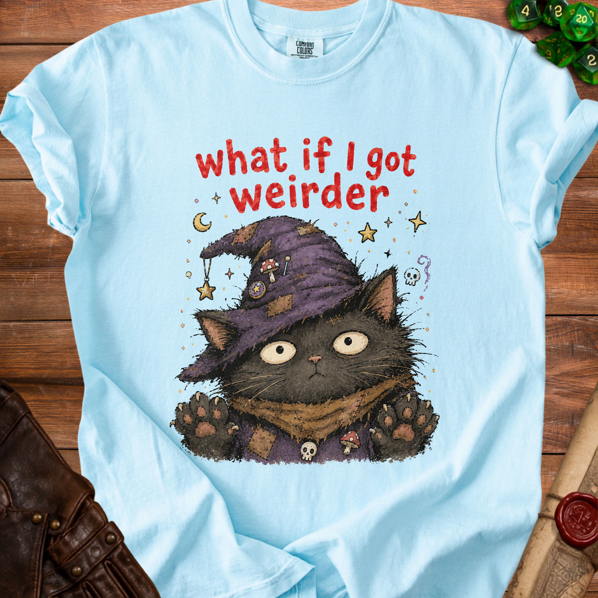Light blue t-shirt with black cat wearing witch hat and "what if I got weirder" text.