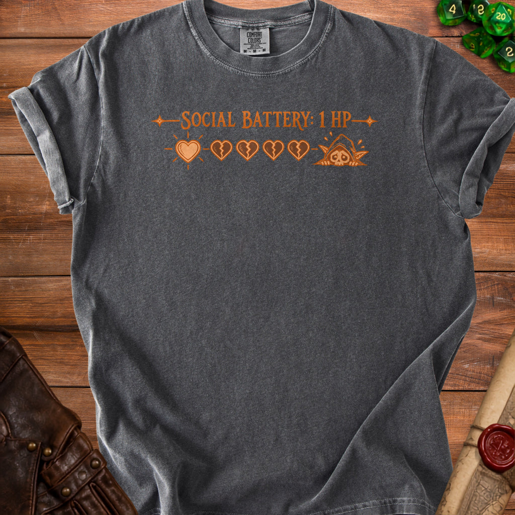 Dark gray t-shirt with orange text "SOCIAL BATTERY: 1 HP" and heart icons.