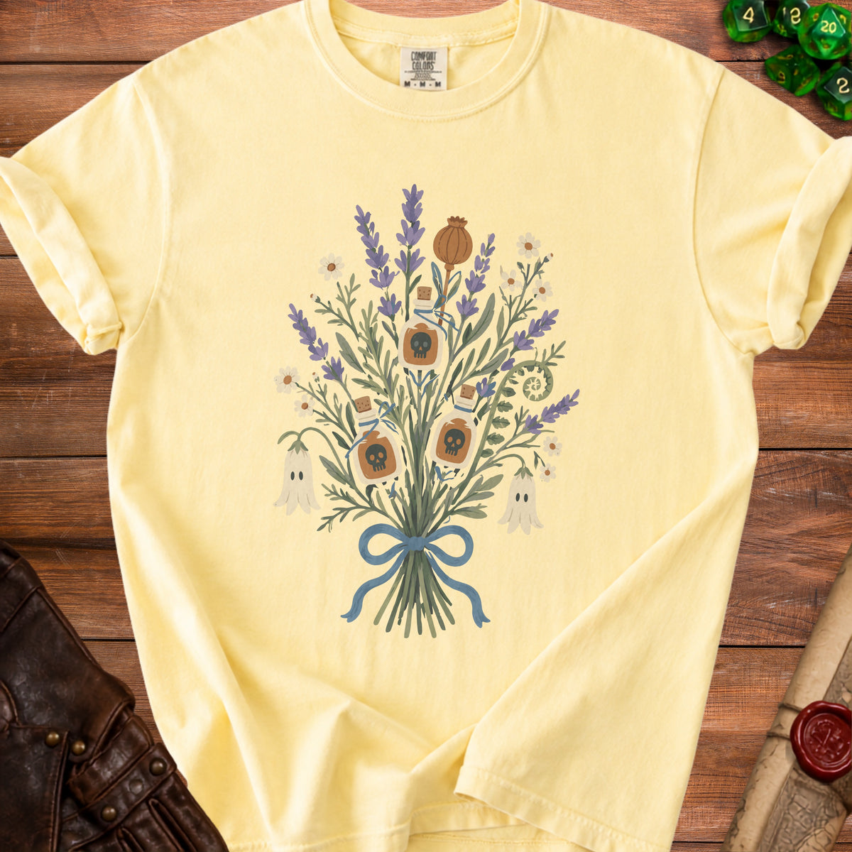 Yellow t-shirt with lavender, ghosts, and skull potion bottle graphic.