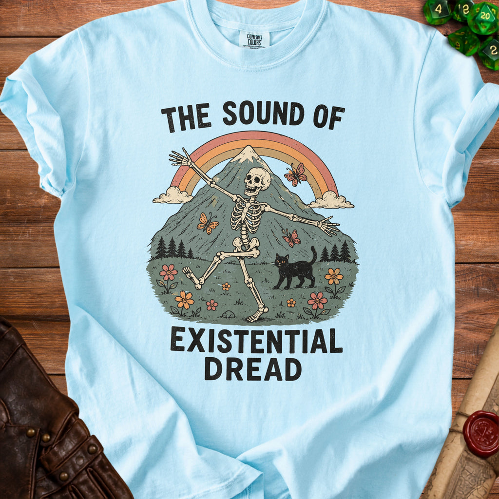 Light blue t-shirt with skeleton, black cat, butterflies, mountains, and text "The Sound of Existential Dread".