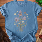 Blue t-shirt with a bouquet of predatory flowers, daisies, and pumpkins.