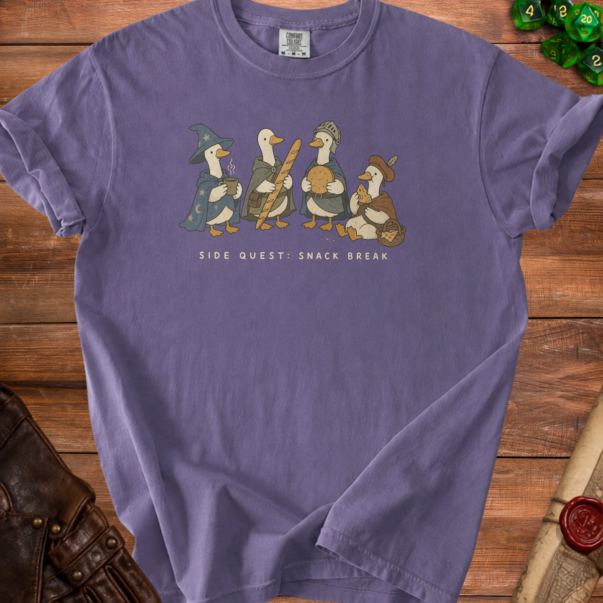 Purple t-shirt featuring illustrated geese dressed as fantasy characters with the text "Side Quest: Snack Break".