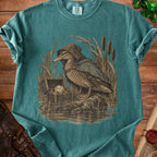 Duck wearing a cloak holds a key next to an open treasure chest with a die.