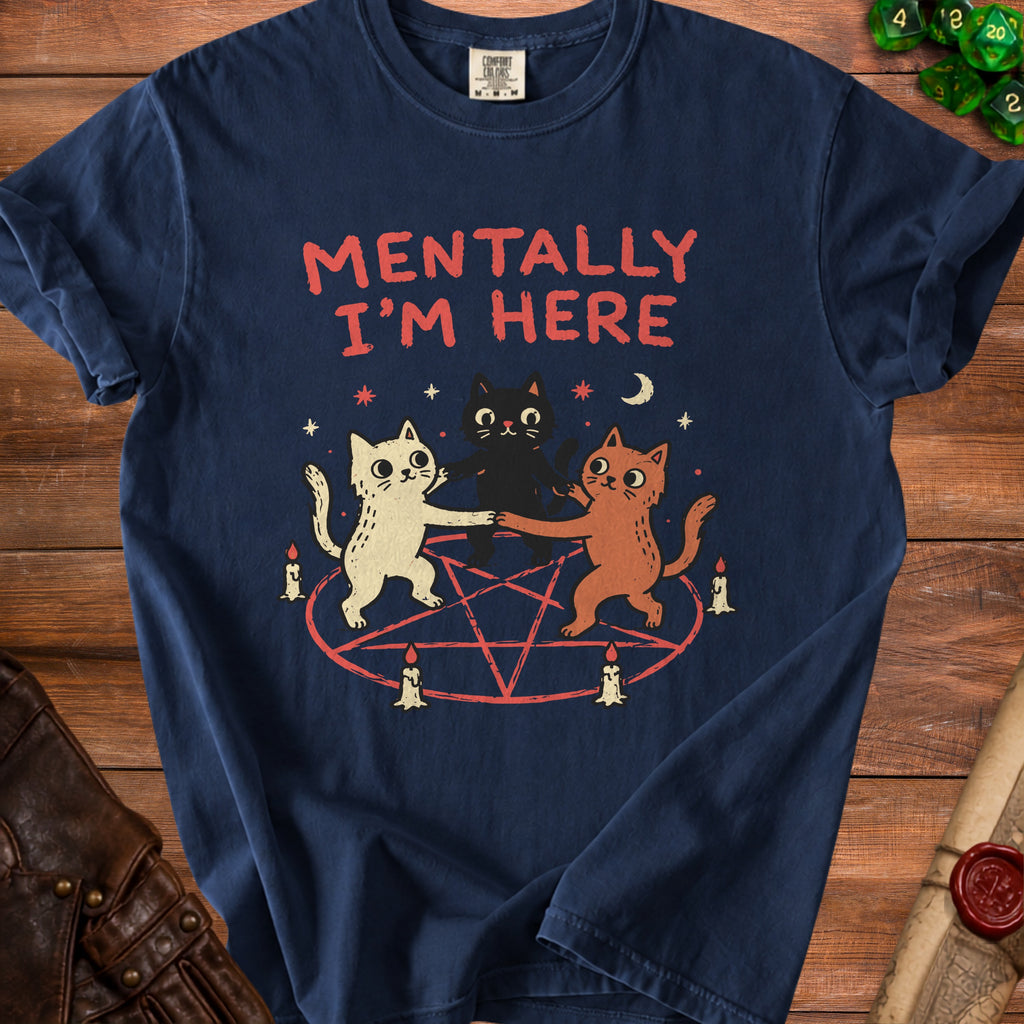 Three cats dance around a pentagram on a dark blue t-shirt with "Mentally I'm Here" text.
