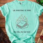 Aqua t-shirt with "UR WRITING IZ FIRE But like, the bad kind" and a cartoon pile of papers on fire.